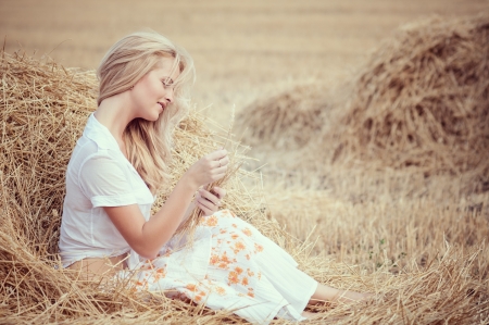 young beautiful woman on fieldの写真素材