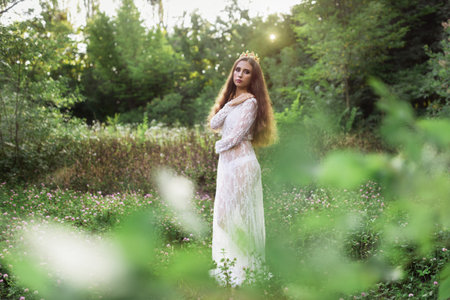 beautiful girl. fantasy young woman in woodsの写真素材