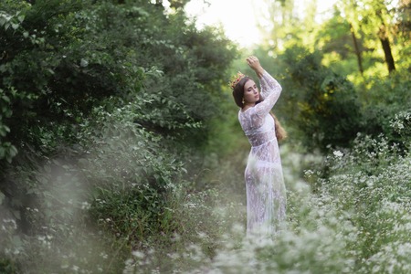 beautiful girl. fantasy young woman in woodsの写真素材