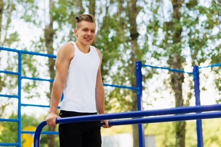 Workout, sportsman pull ups the horizontal barの写真素材