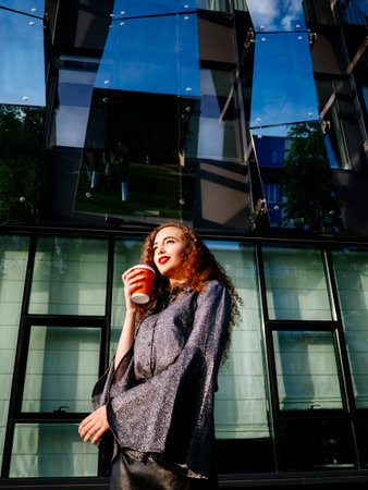 Young Business Woman With Coffee on office center background