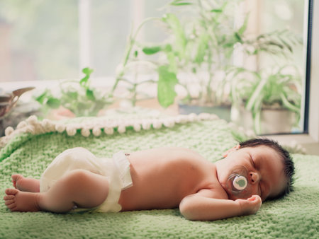 Cute tiny kid napping peacefully in his bad