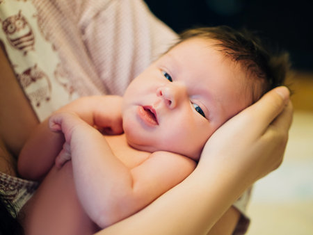 Mother and her sweet baby in the room at home
