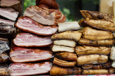 slices of bacon and smoked meat lie on the counterの写真素材