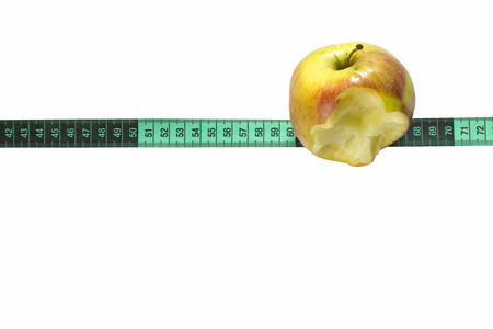 bitten off apple and centimeter on isolated backgroundの写真素材