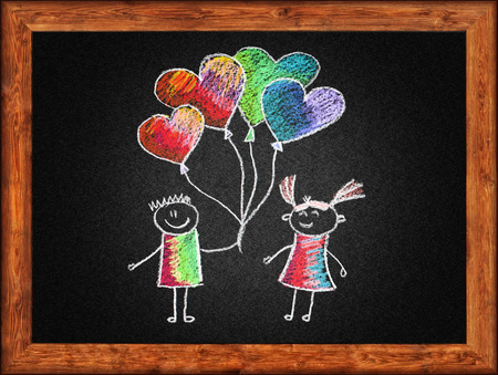 Black blackboard with frame and kids drawing. Color chalksの写真素材