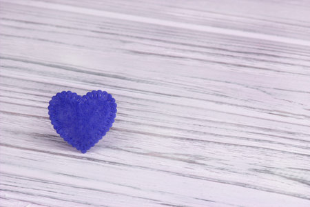 Blue heart of felt on a white wooden background. Valentine Day.Greeting card.Weddingの写真素材