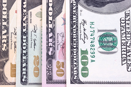 Abstract dollar bills of different denominations backgroundの写真素材