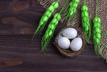 Easter decoration with Easter eggs in the nest burlap cloth green spikeletsの写真素材