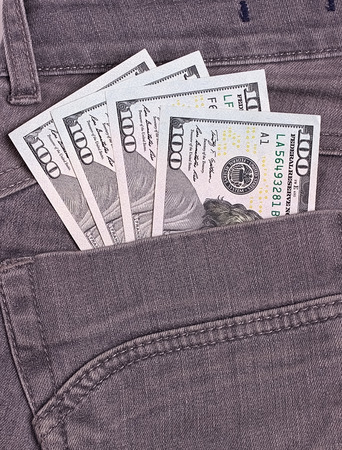 Dollars bills in black jeans back pocketの写真素材