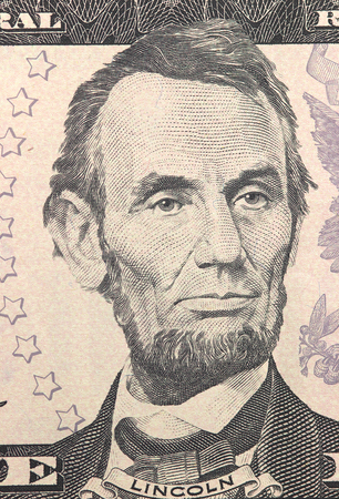 Abraham Lincoln face on US five or 5 dollars bill macro, united states money closeupの写真素材