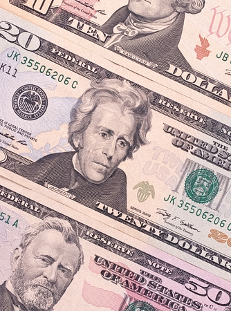 American dollar bills of different denominations abstract backgroundの写真素材