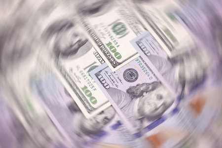 American dollar of different denominations blured background