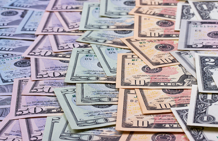 American dollar of different denominations blured backgroundの写真素材