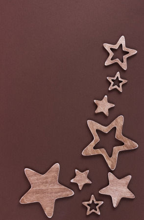 Brown five-pointed wooden stars on brown cardboardの写真素材