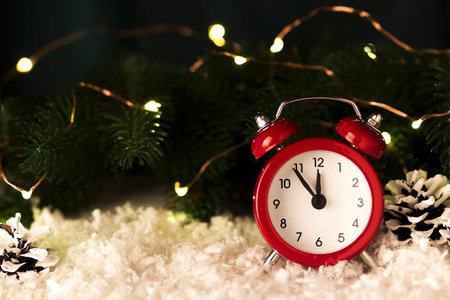 Christmas background with red alarm clock snowflakes cones and cones