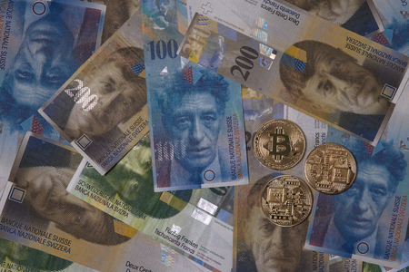 Golden bitcoin on swiss franc money backgroundの写真素材
