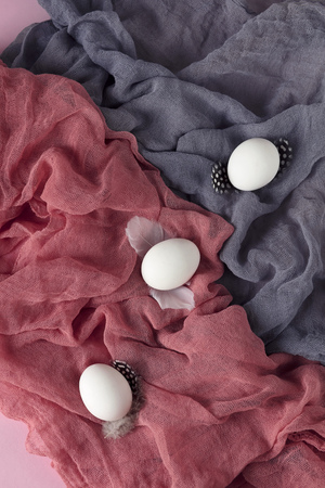 Easter decoration with quail eggs on gray fabric background.の写真素材