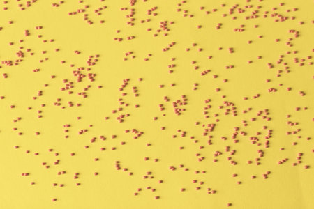 Easter decoration with red candy powder red on yellow background