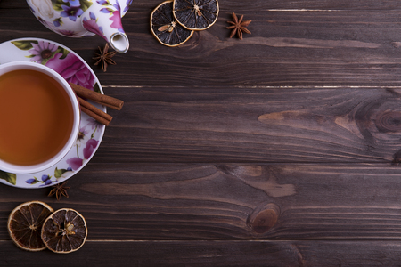 Teapot tea cup on brown wooden tableの写真素材