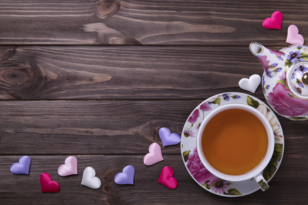 Teapot tea cup on brown wooden tableの写真素材