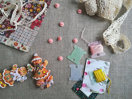 Handmade, needlework and embroidery. Christmas gingerbread man, buttons and threads as background....
