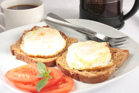 Simple breakfast of eggs on toast and coffeeの写真素材