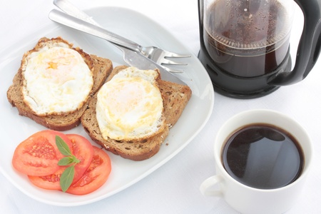 Breakfast of eggs on toast with French coffeeの写真素材