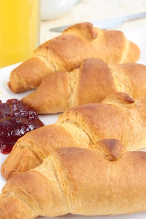 A breakfast of croissants with jam and orange juiceの写真素材