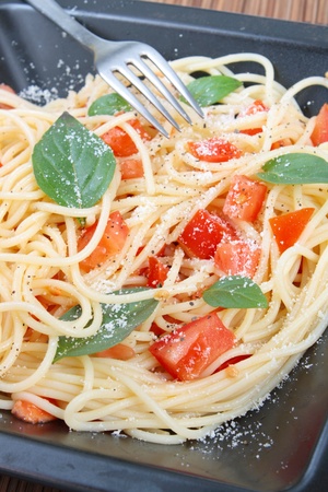 Spaghetti with tomatoes and basilの写真素材