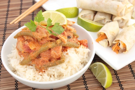 Thai chicken curry with spring rollsの写真素材