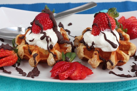 Strawberry waffles with cream on blueの写真素材