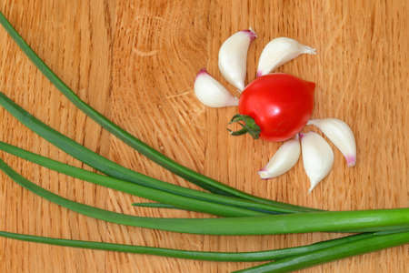 Food background. Space for text. Cherry tomato, green onion, garlic. Still life. Healthy vegetarian cuisine.の写真素材