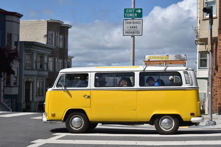 classic yellow volkswagen van crossing the street in San Francisco.のeditorial素材
