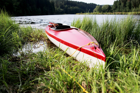 Young man in a kayak fishing at river.の写真素材