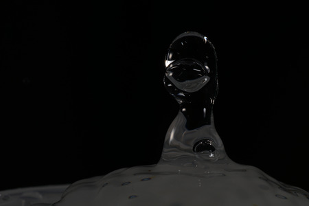 Water drops with short exposure photographed with black backgroundの写真素材