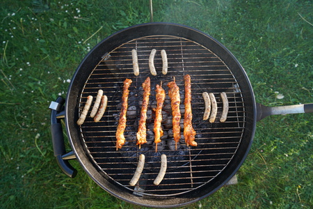 Sausages barbecue with a charcoal barbecue in the gardenの写真素材