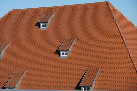 Roof tiles made of baked clay are particularly beautiful and durable on German roofsの写真素材