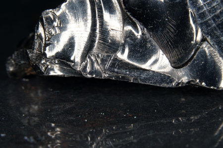 A black rock also called healing stone shungite, which consists mainly of carbon was photographed...