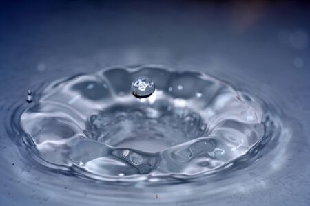 Water drops photographed with higspeed flashes and dropper in the studioの写真素材