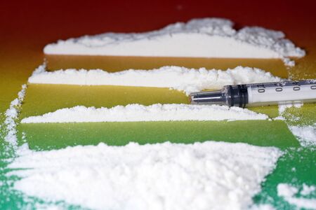 Flour that should look like a white drug with macro lens photographed in front of colorful gradient in the studioの写真素材