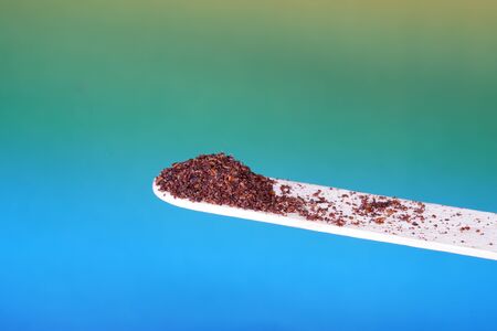 Sumac spice with macro lens photographed against colorful gradient in studioの写真素材