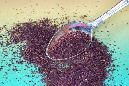 Sumac spice with macro lens photographed against colorful gradient in studioの写真素材