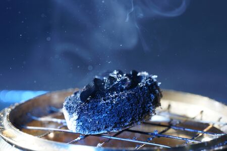 Smoke from an incense stick with color foils Photographed in the studioの写真素材