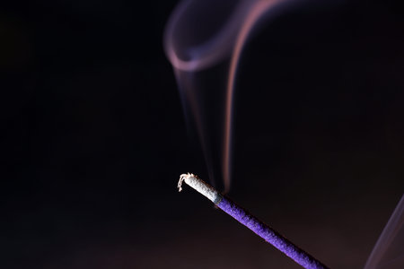Smoke from an incense stick with color foils Photographed in the studioの写真素材