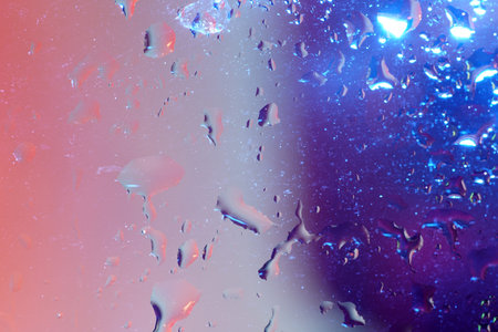 Drops of water on a glass sheet with flashes and color film Photographed in the studio