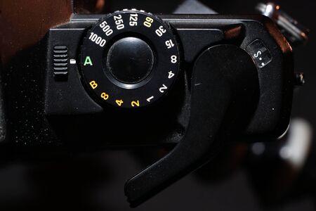 Setting wheel for ISO and aperture on an old camera photographed in the studioの写真素材