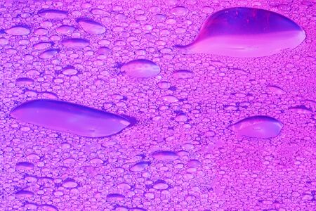 Water drops with high-speed flashes and automatic drip photographed in the studioの写真素材