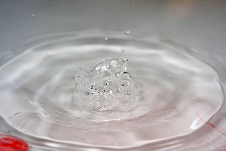 Water drops with high-speed flashes and automatic drip photographed in the studioの写真素材