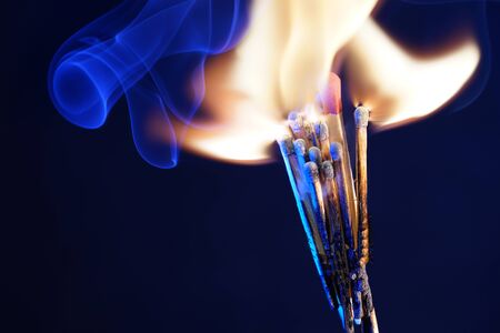 Lit matches and blown out in the studio photographed with colorful foils before the flashesの写真素材